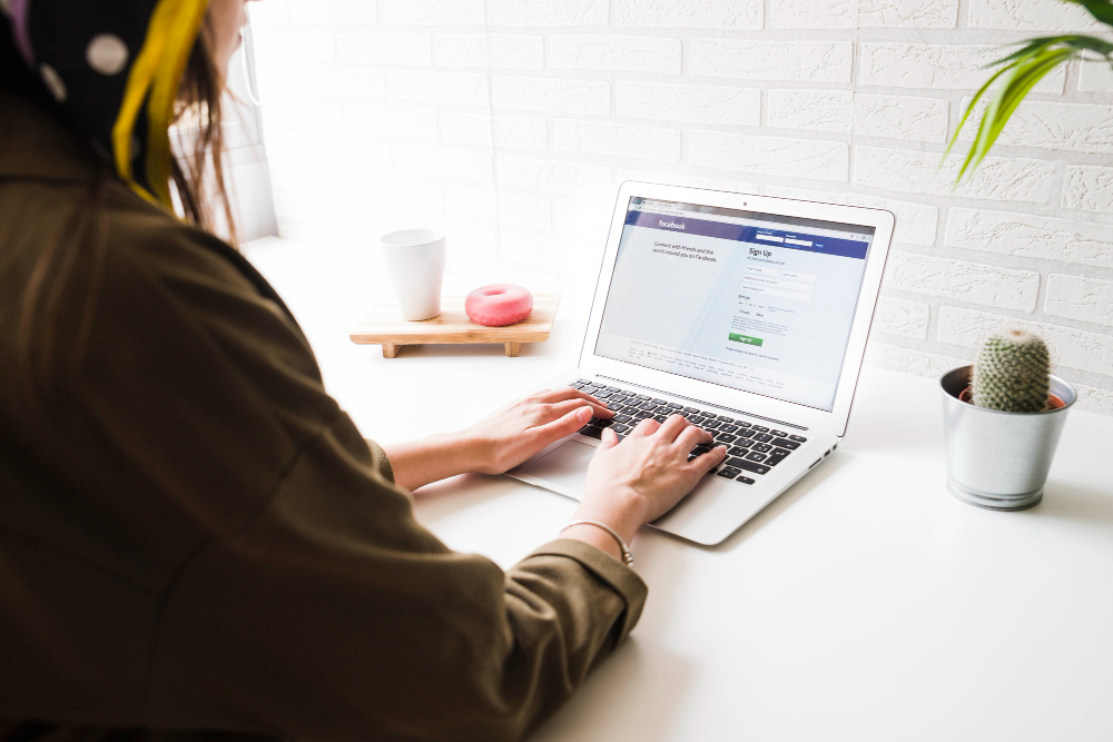 User signing in on a laptop at a desk