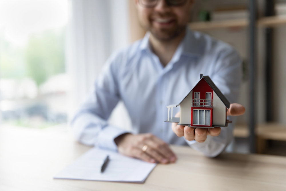 Close up focus on house model in male hands.