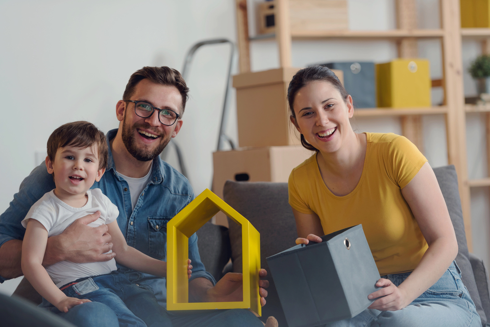 Happy family, father and baby son in new flat